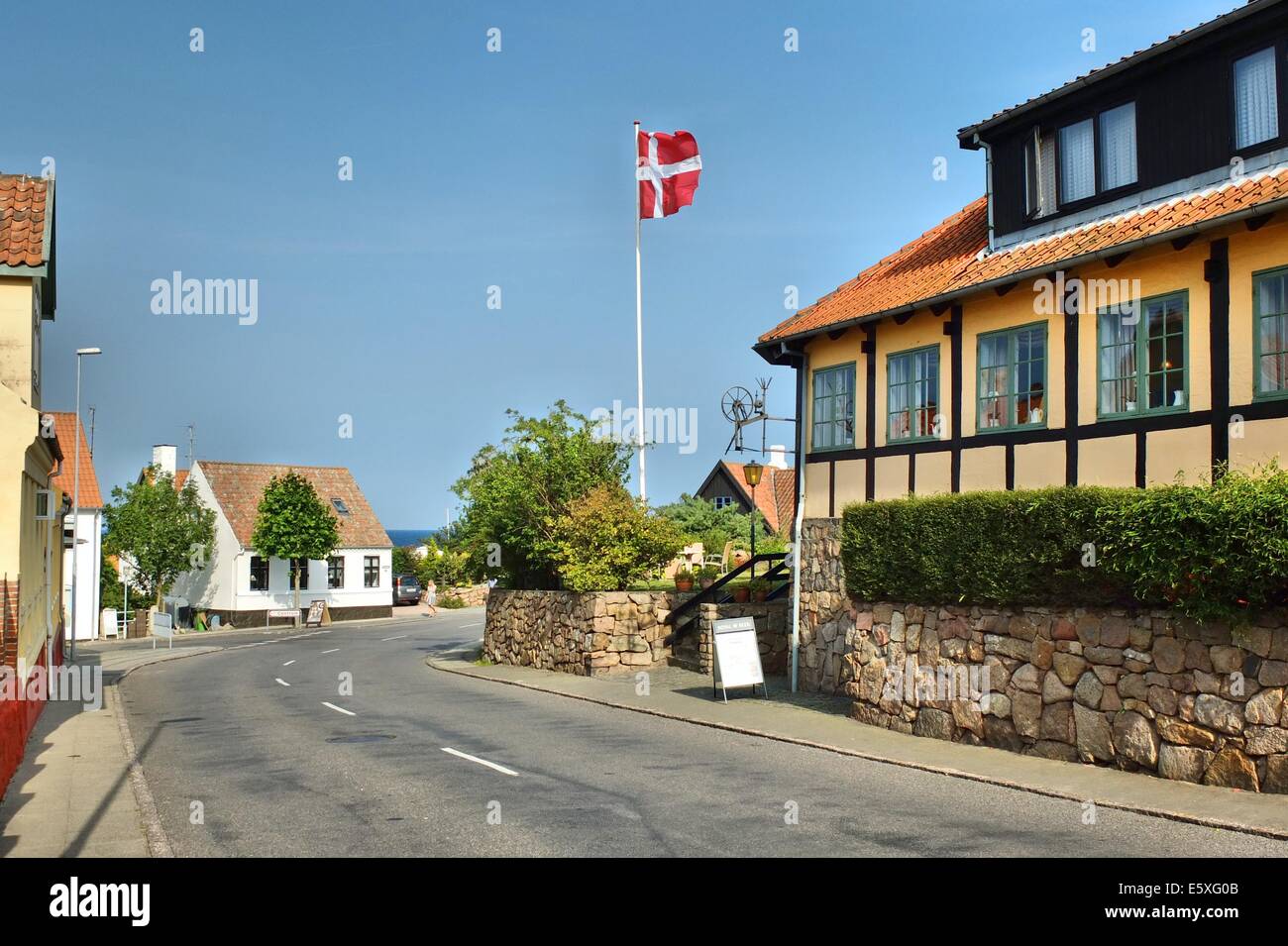 Denmark, Bornholm Island Pictures taken between 1st and 5th August 2014.  Pictured: Street in the Allinge city with Danish flag on the wind Stock Photo