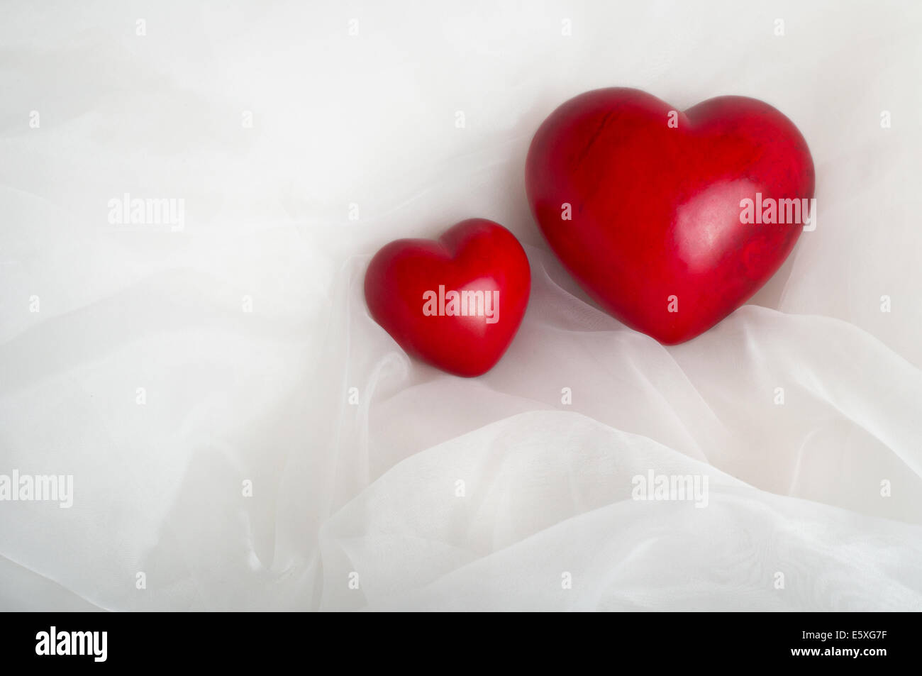 Two red hearts - childbirth concept (child/mother) Stock Photo