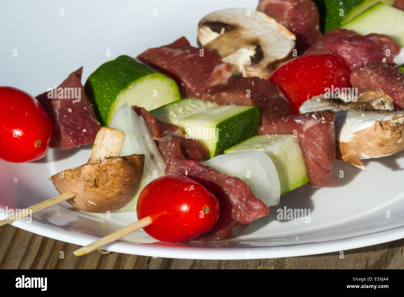 meat skewers on a plate with seasonings for an outdoor meal Stock Photo