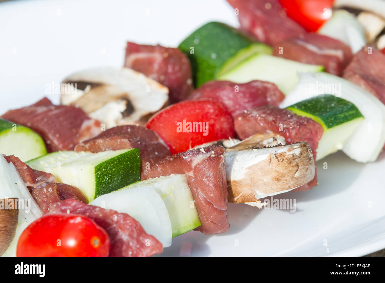 meat skewers on a plate with seasonings for an outdoor meal Stock Photo