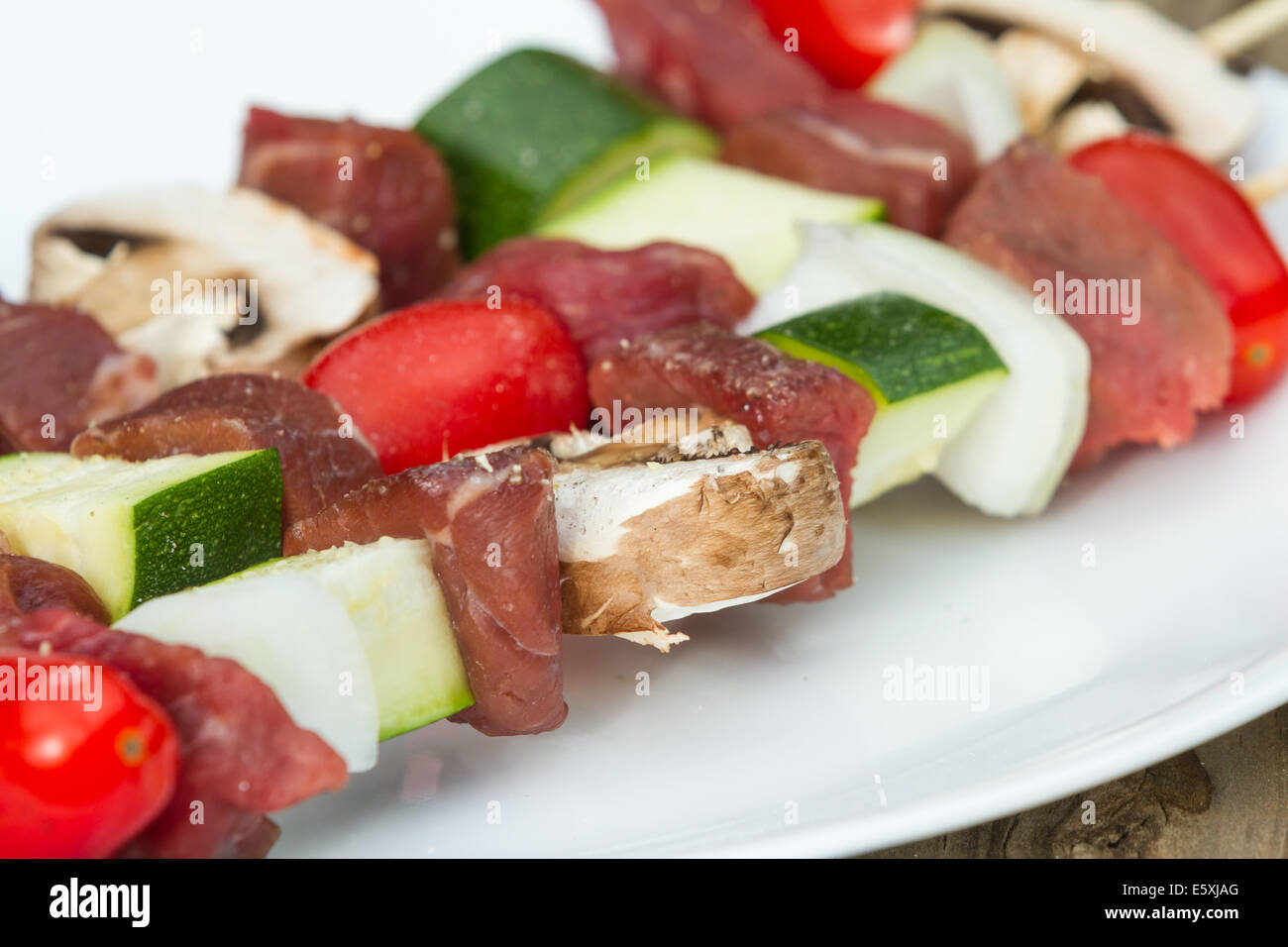 meat skewers on a plate with seasonings for an outdoor meal Stock Photo