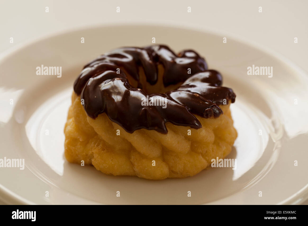 Chocolate frosted French cruller donut Stock Photo Alamy