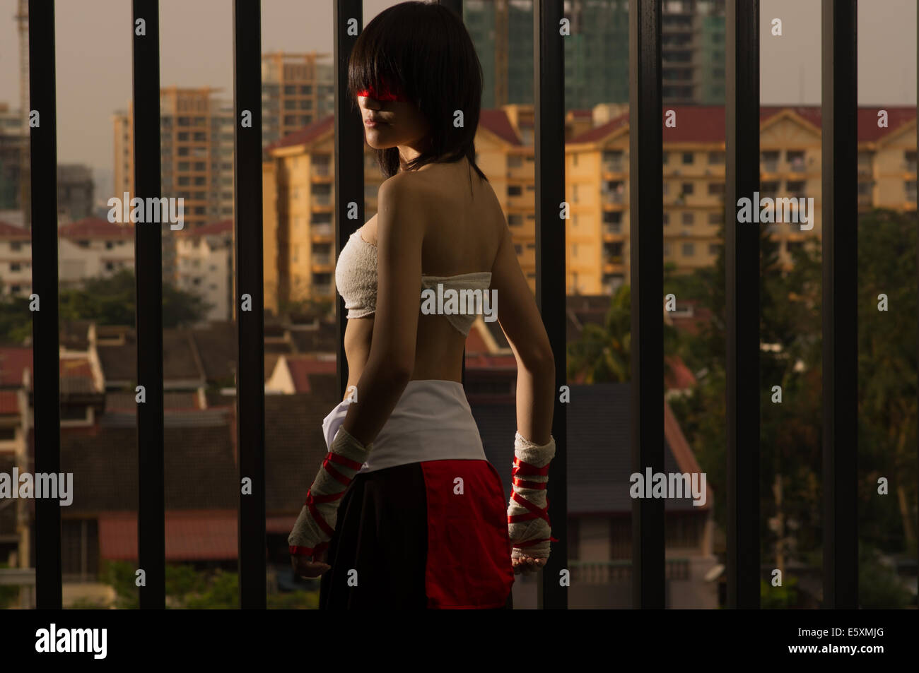 a female cosplaying as lee sin, the blind monk from league of legends Stock Photo