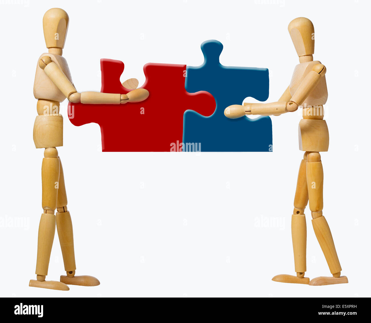 two manikins joint puzzle pieces in cooperation Stock Photo