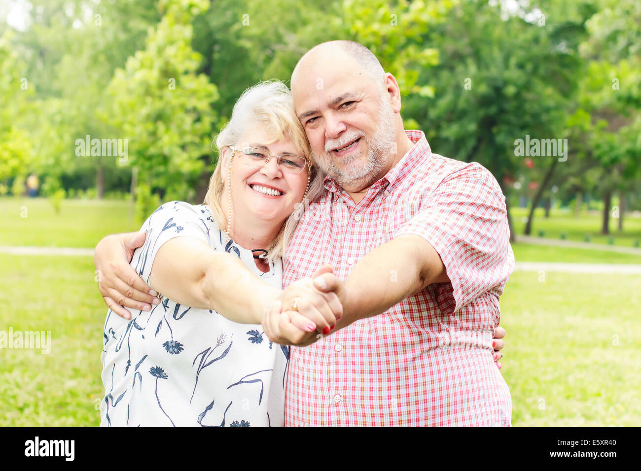 Romantic senior couple relaxing in the park Stock Photo - Alamy