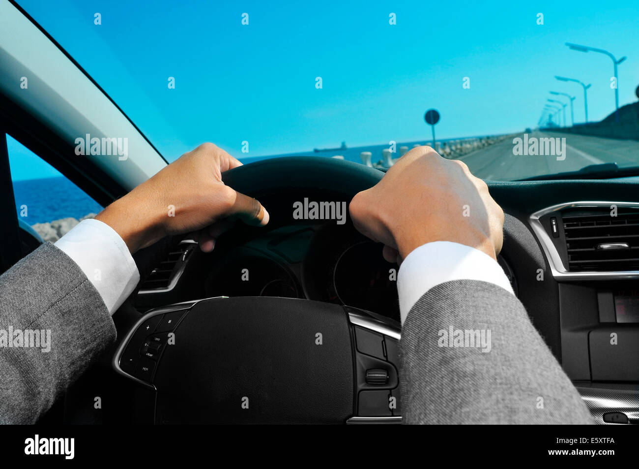 closeup of a man in suit driving a car Stock Photo
