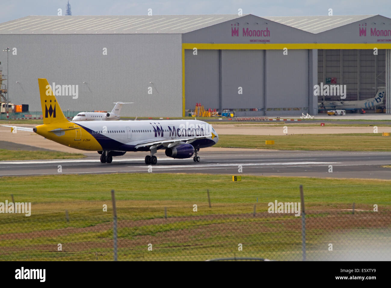 Monarch Airlines aircraft taxiing near Monarch hangers. Birmingham Airport Stock Photo