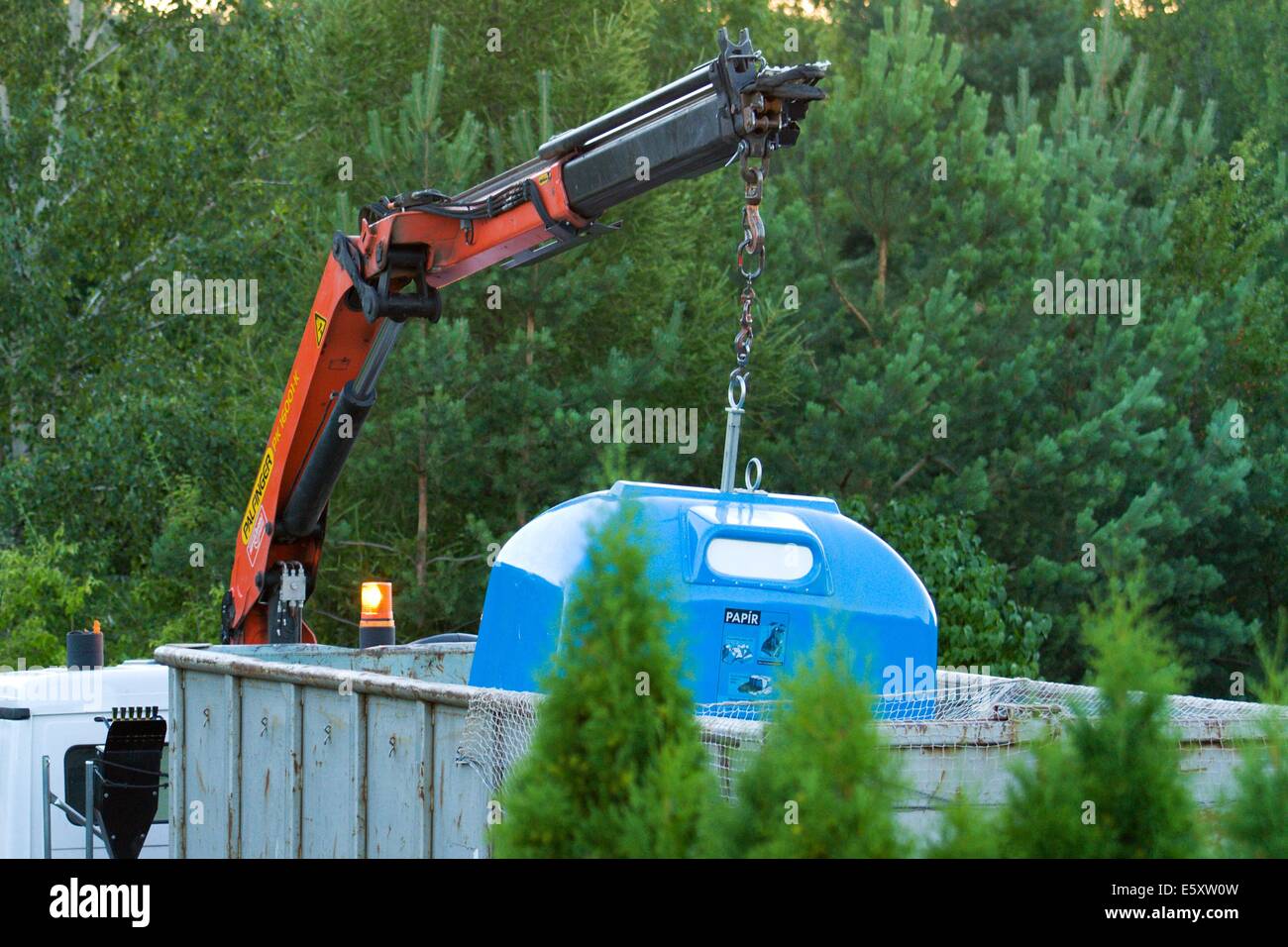 collecting of separated waste bin with hydraulic crane Stock Photo