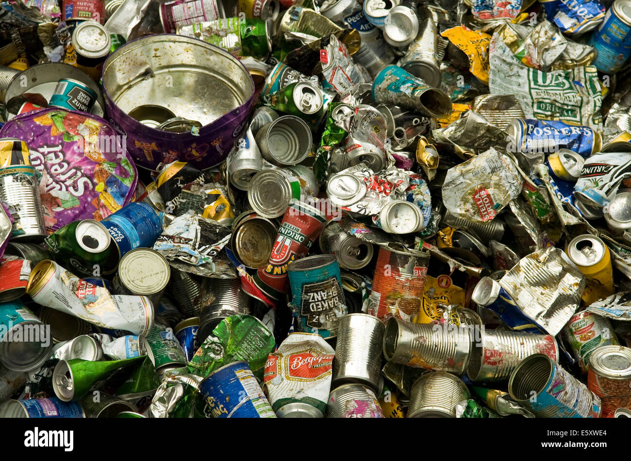 Close up on crushed food and drink cans awaiting recycling at a