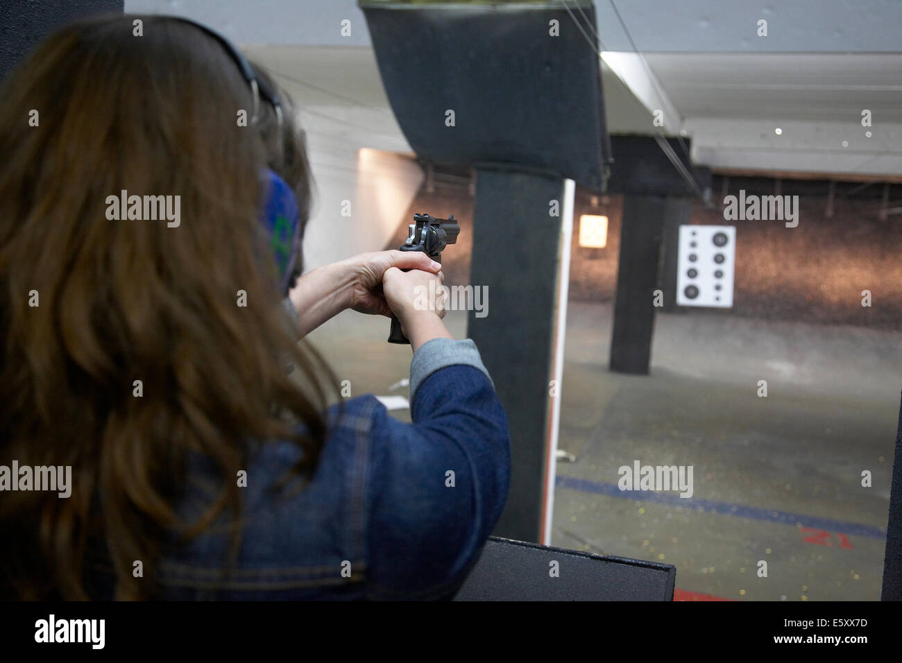 Woman holding gun from behind hires stock photography and images Alamy