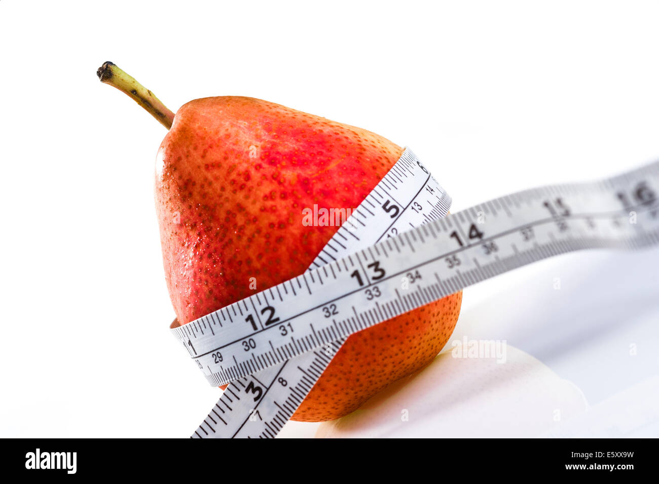Red pear with tape measure.obesity, weight loss, dieting. Stock Photo