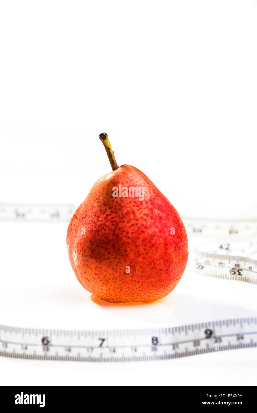 Red pear with tape measure.obesity, weight loss, dieting. Stock Photo