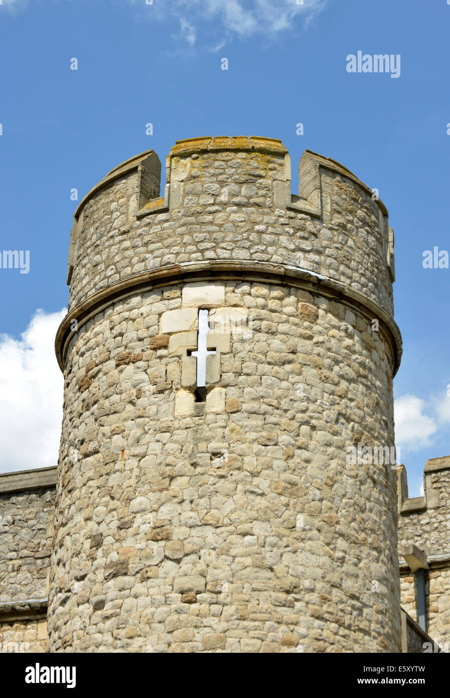 Battlements and arrow slit on a round tower of the Tower of London's walls Stock Photo