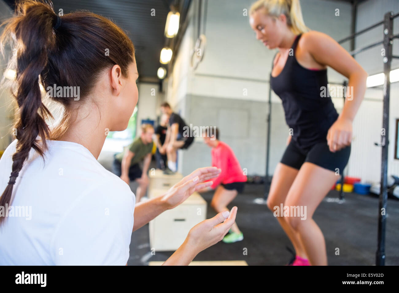 Instructor Encouraging Athlete In Box Jumping Stock Photo