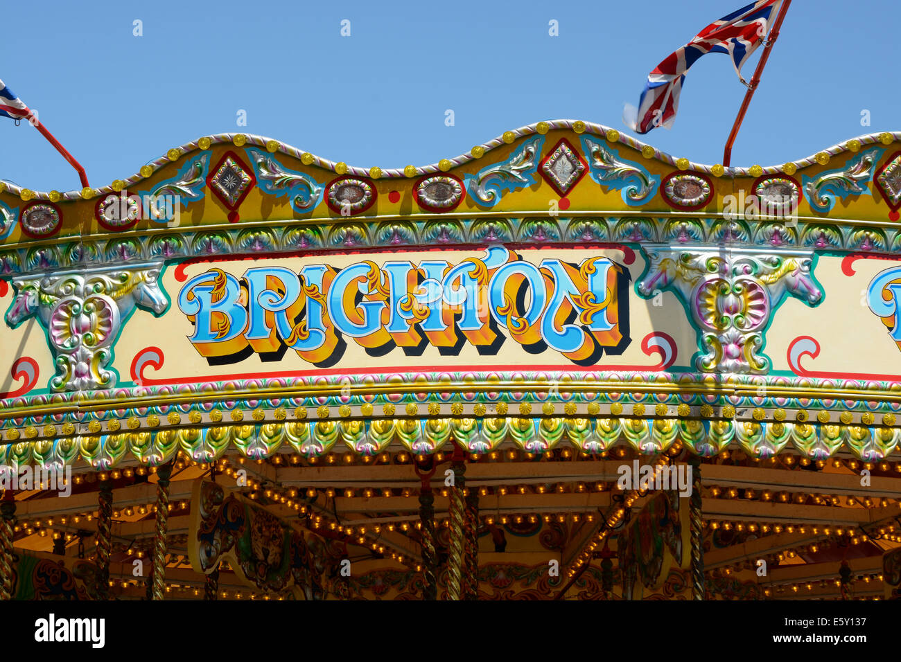 Brighton sign on old fashioned traditional roundabout. On the pier at ...