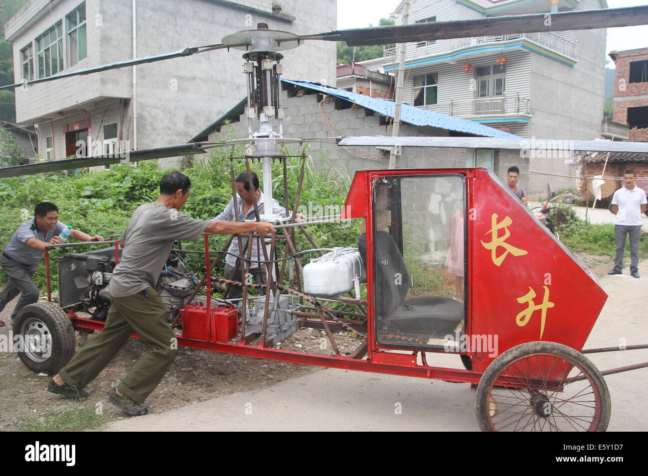 Dexing, China. 7th Aug, 2014. AUGUST 07: Jiang Changgen prepares for test flight at Dajia village on August 7, 2014 in Dexing, Jiangxi Province of China. 52-year-old Jiang Changgen spent two years and 100,000 yuan (16,200 USD) making the coaxial helicopter. The helicopter is 4 meters long, 2.65 meters tall and weighs 900 kilograms. Its rotor blade is eight meters long. Jiang tried more than ten minutes, but he didn't succeed. Credit:  SIPA Asia/ZUMA Wire/Alamy Live News Stock Photo