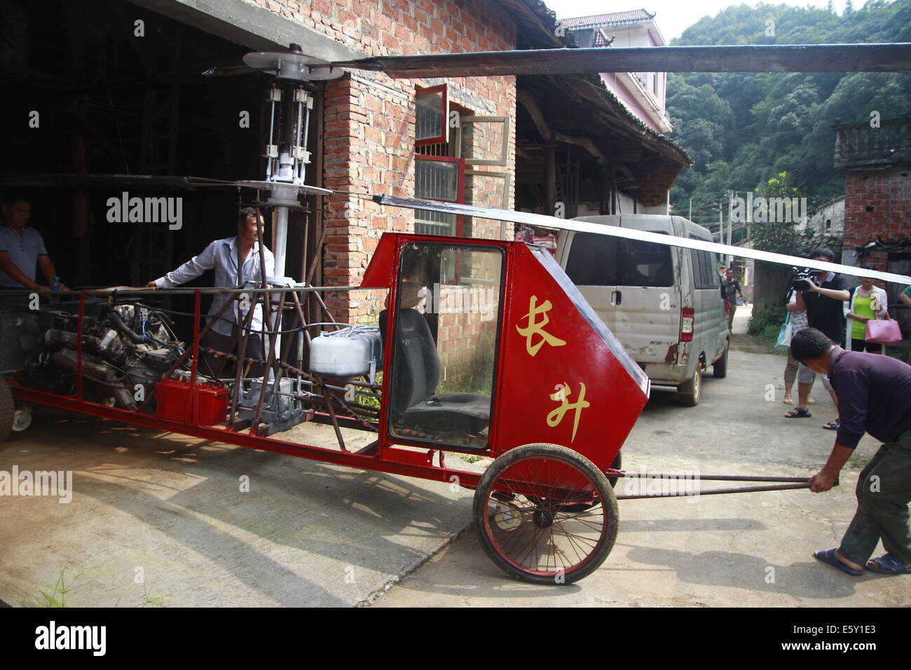 Dexing, China. 7th Aug, 2014. AUGUST 07: Jiang Changgen prepares for test flight at Dajia village on August 7, 2014 in Dexing, Jiangxi Province of China. 52-year-old Jiang Changgen spent two years and 100,000 yuan (16,200 USD) making the coaxial helicopter. The helicopter is 4 meters long, 2.65 meters tall and weighs 900 kilograms. Its rotor blade is eight meters long. Jiang tried more than ten minutes, but he didn't succeed. Credit:  SIPA Asia/ZUMA Wire/Alamy Live News Stock Photo