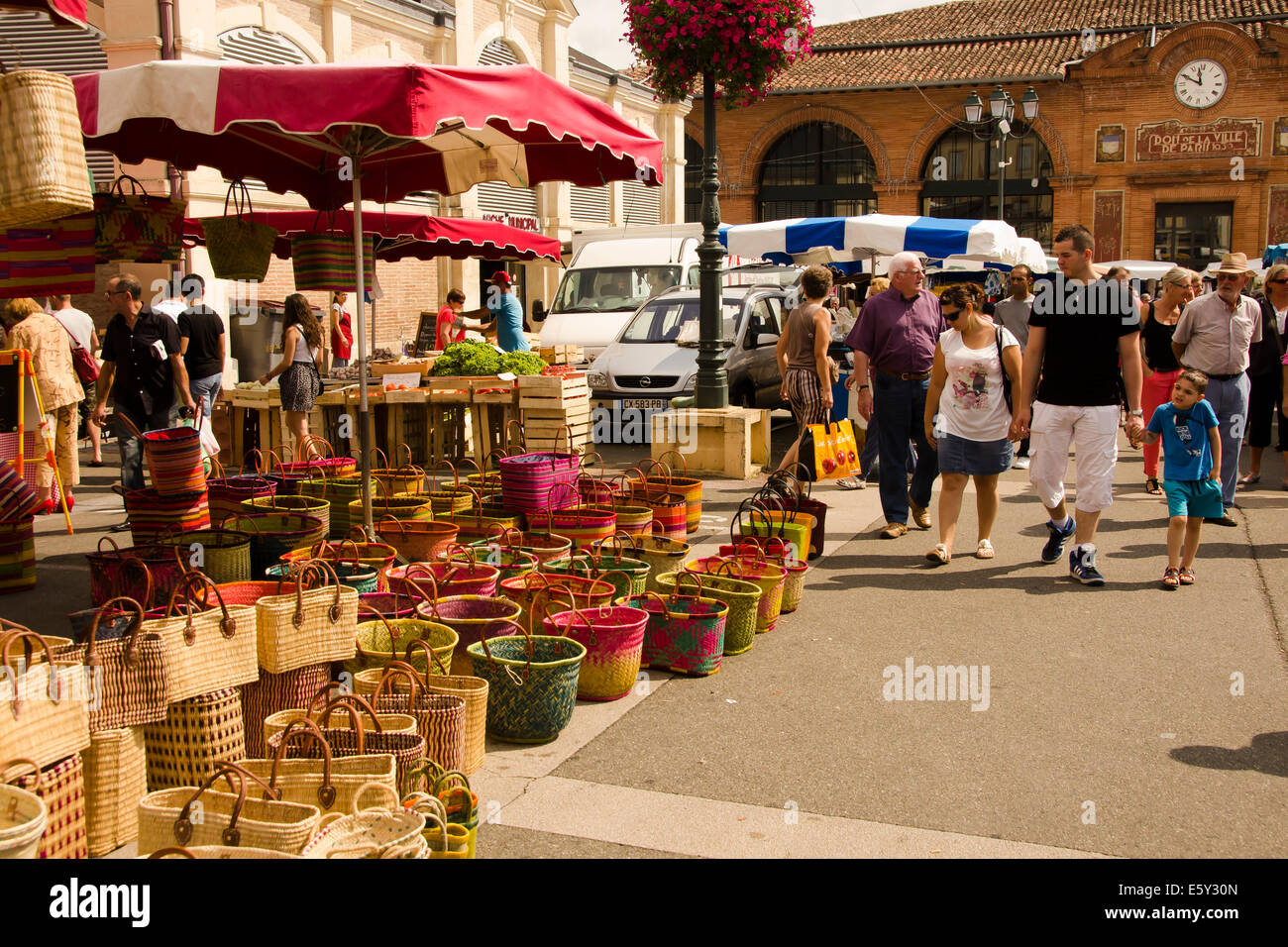 Colourful straw baskets for sale in outdoor traditional Sunday street market in Moissac, southwest France. Stock Photo