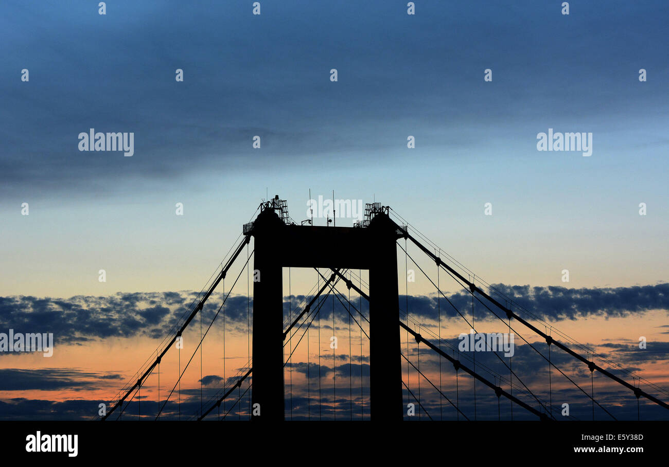 The sun sets over the Tamar Bridge on the Devon & Cornwall border Plymouth. Stock Photo