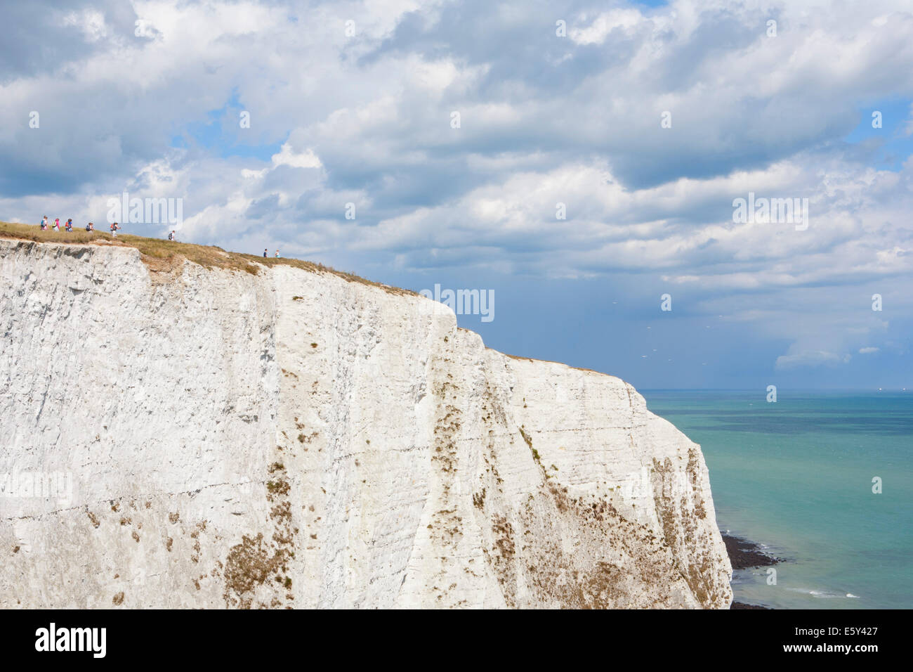 PEOPLE WALKING ALONG WHITE CLIFFS OF DOVER Stock Photo