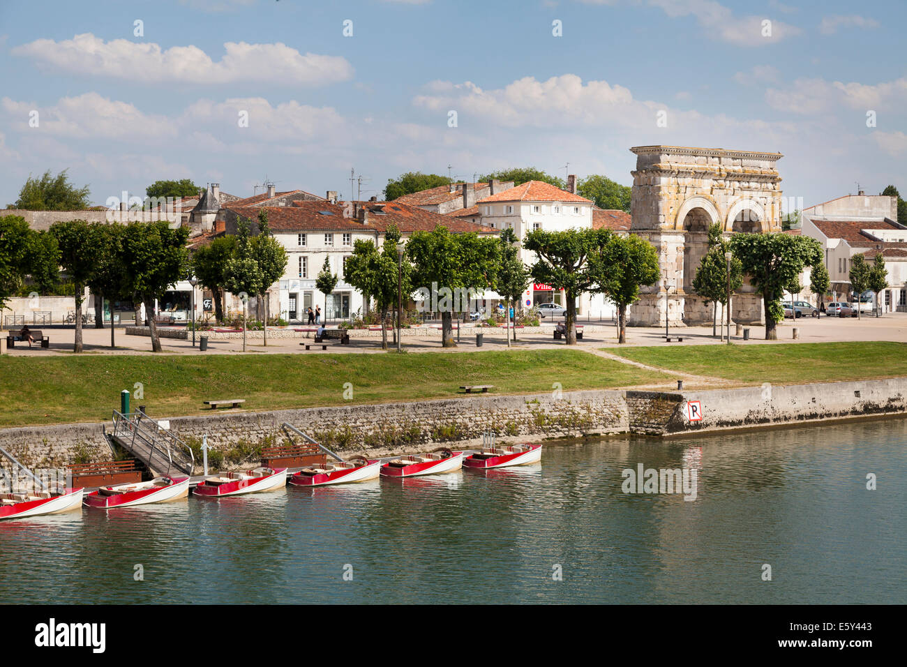 Arch of Germanicus on the right bank with moored pleasure boats on the River Charente. Stock Photo
