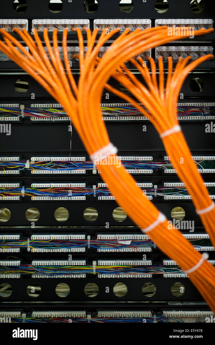 Network cables connected to computer mainframe Stock Photo