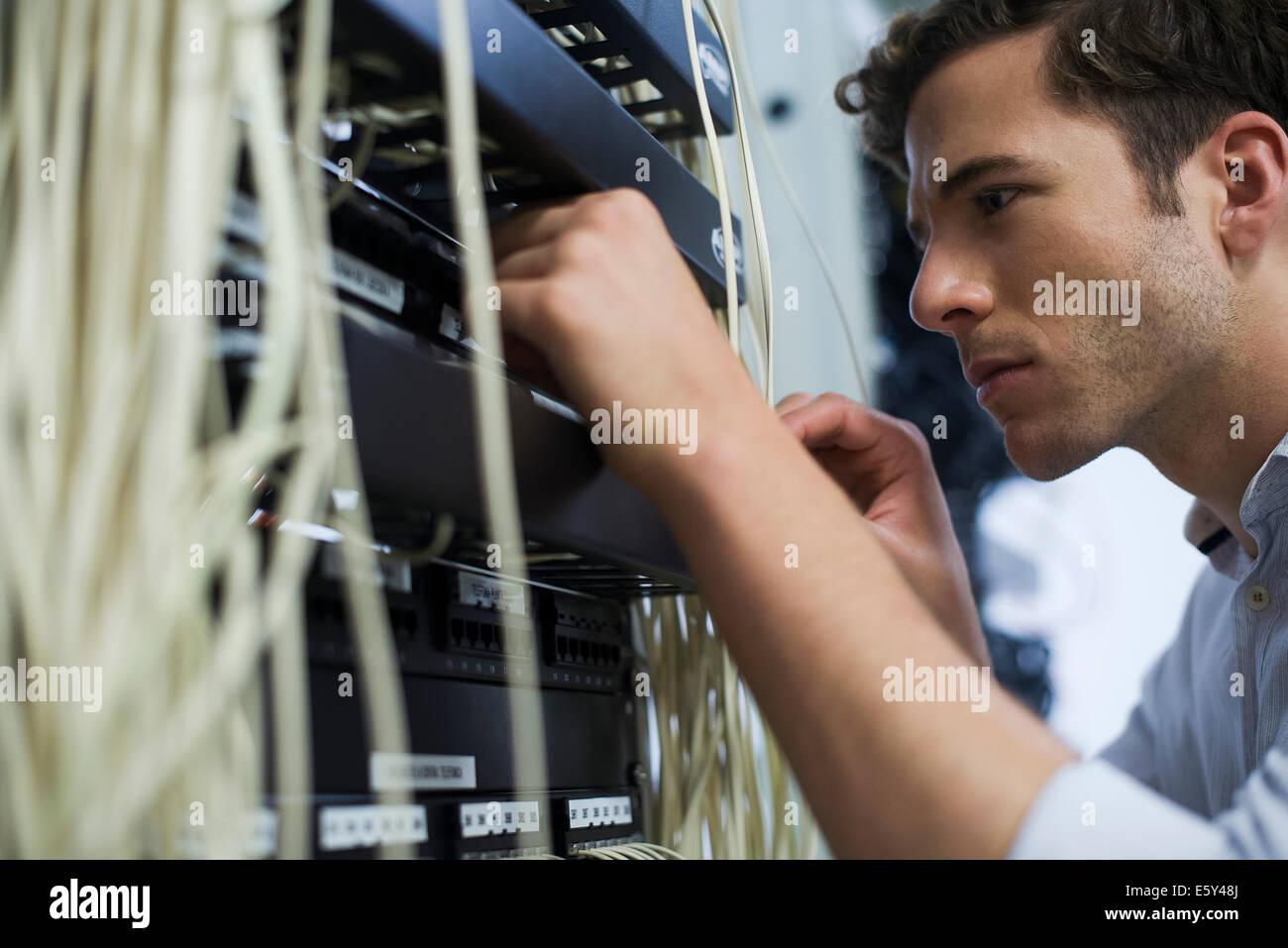 Computer technician performing maintenance on computer networking