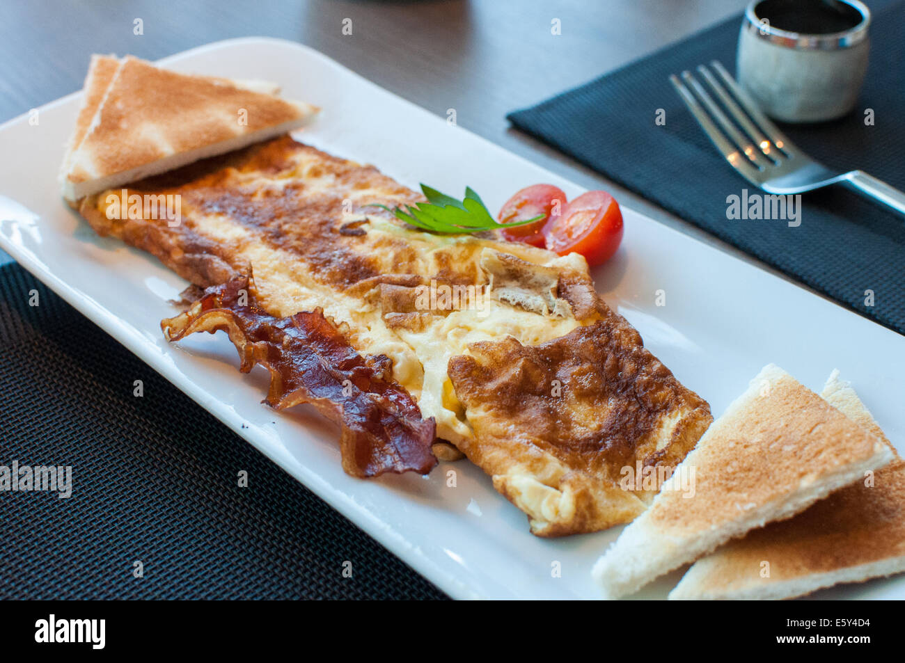 Egg omelette with crispy bacon Stock Photo