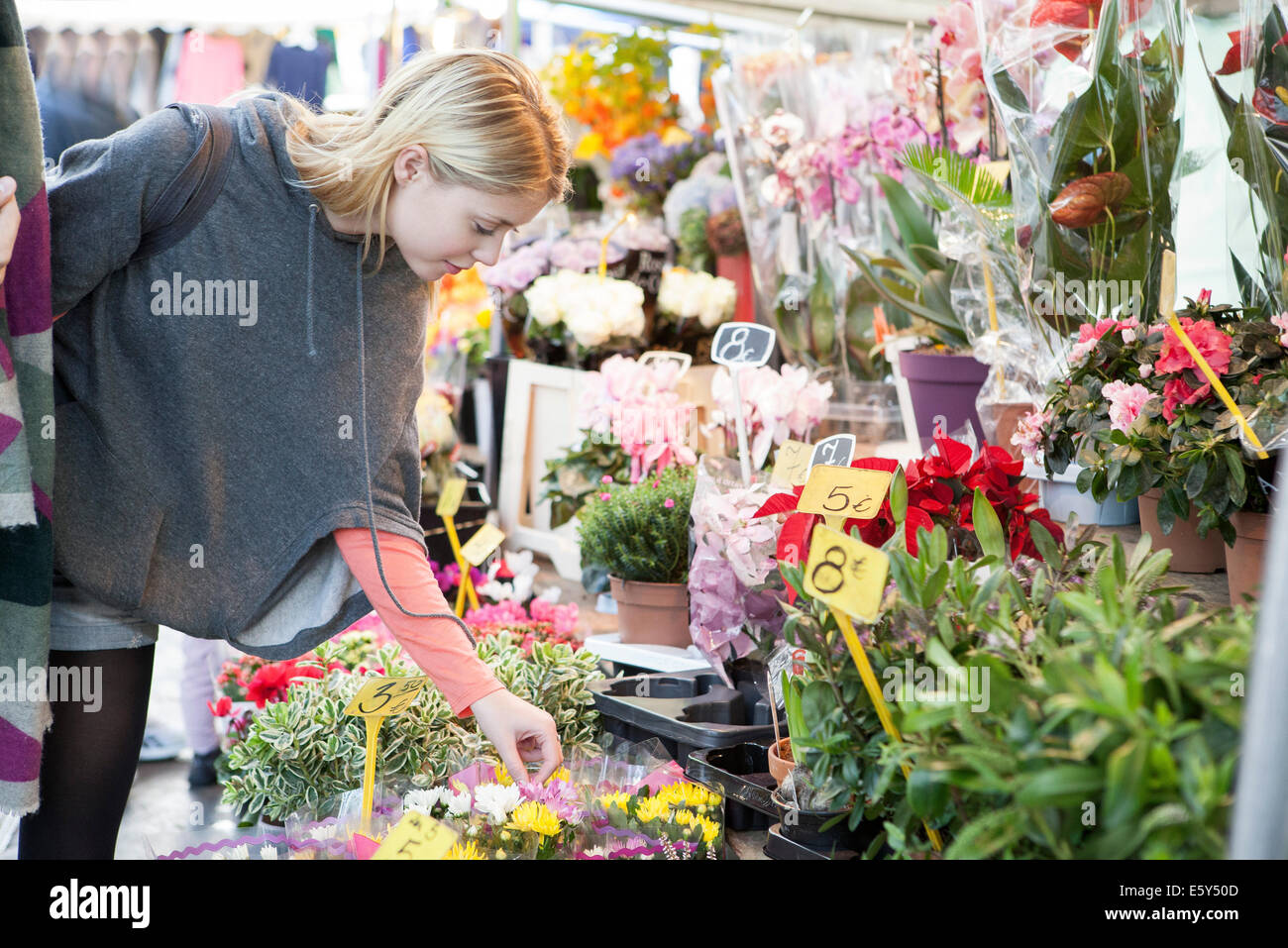 Woman in flower shop browsing bouquet selection Stock Photo