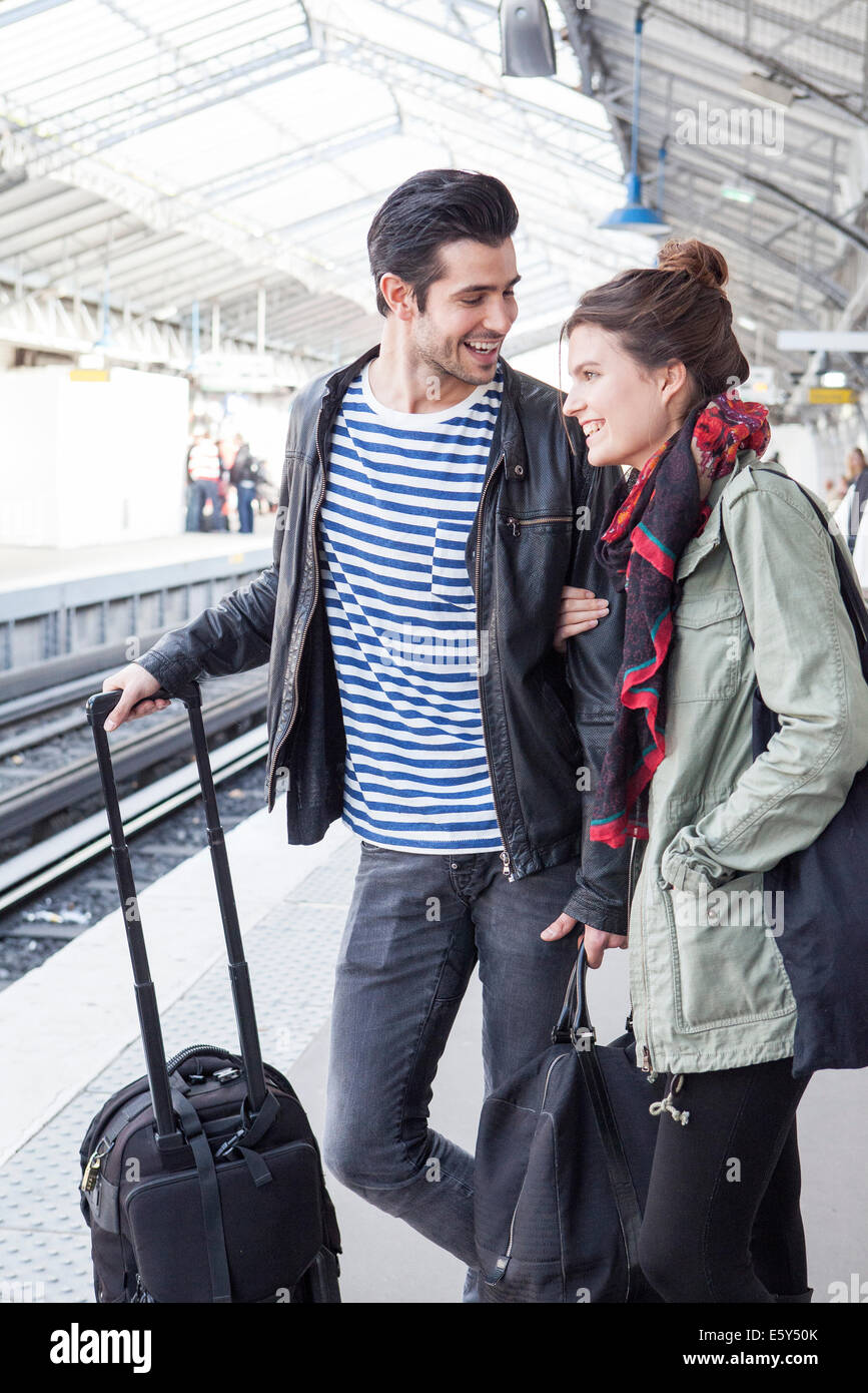 Couple with luggage on train platform Stock Photo Alamy