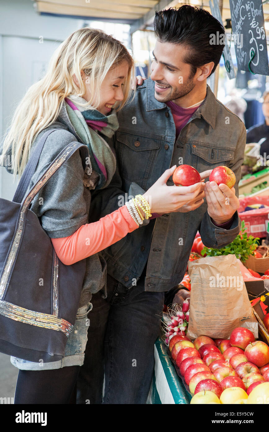 Young couple at greengrocer's shopping for fresh fruits and vegetables Stock Photo