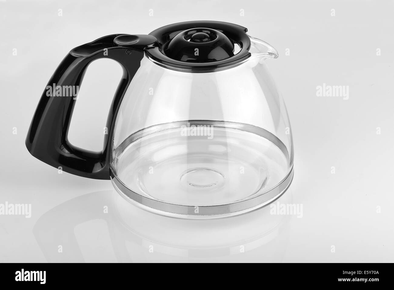 a empty coffee pot on a glossy white table Stock Photo