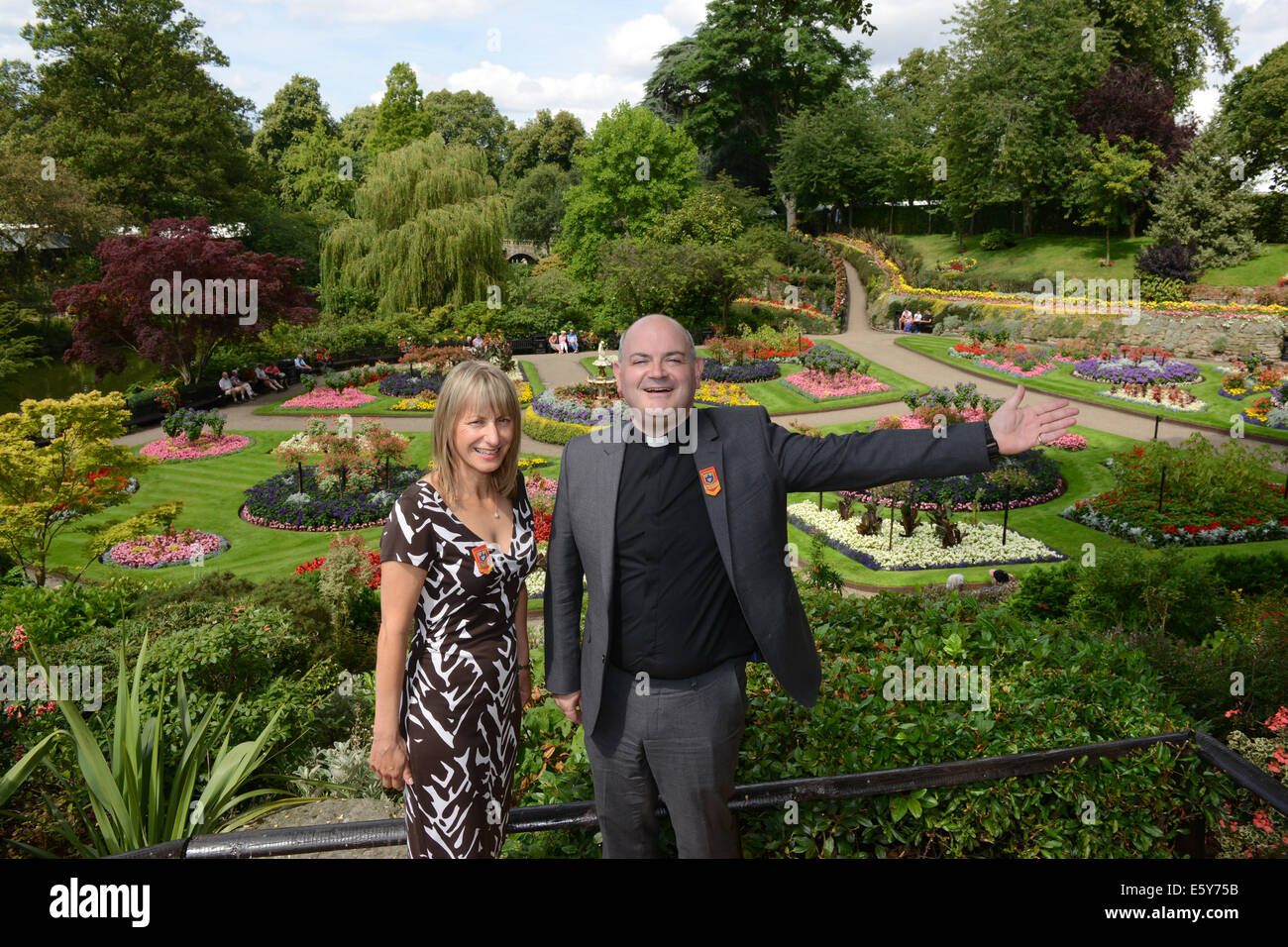 Shrewsbury Flower Show 8th August 2014. The Canon Chancellor of St Paul's Cathedral in London Rev Mark Oakley returned to his home town to declare the show open with Society Chairwoman Donna Hamer in the Dingle. Rev Oakley is this years President of  Shropshire Horticultural Society. Credit:  David Bagnall/Alamy Live News Stock Photo