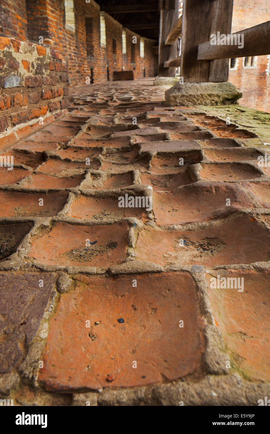 Worn-out red bricks in corridor and inner court of the medieval Beersel Castle, Belgium Stock Photo