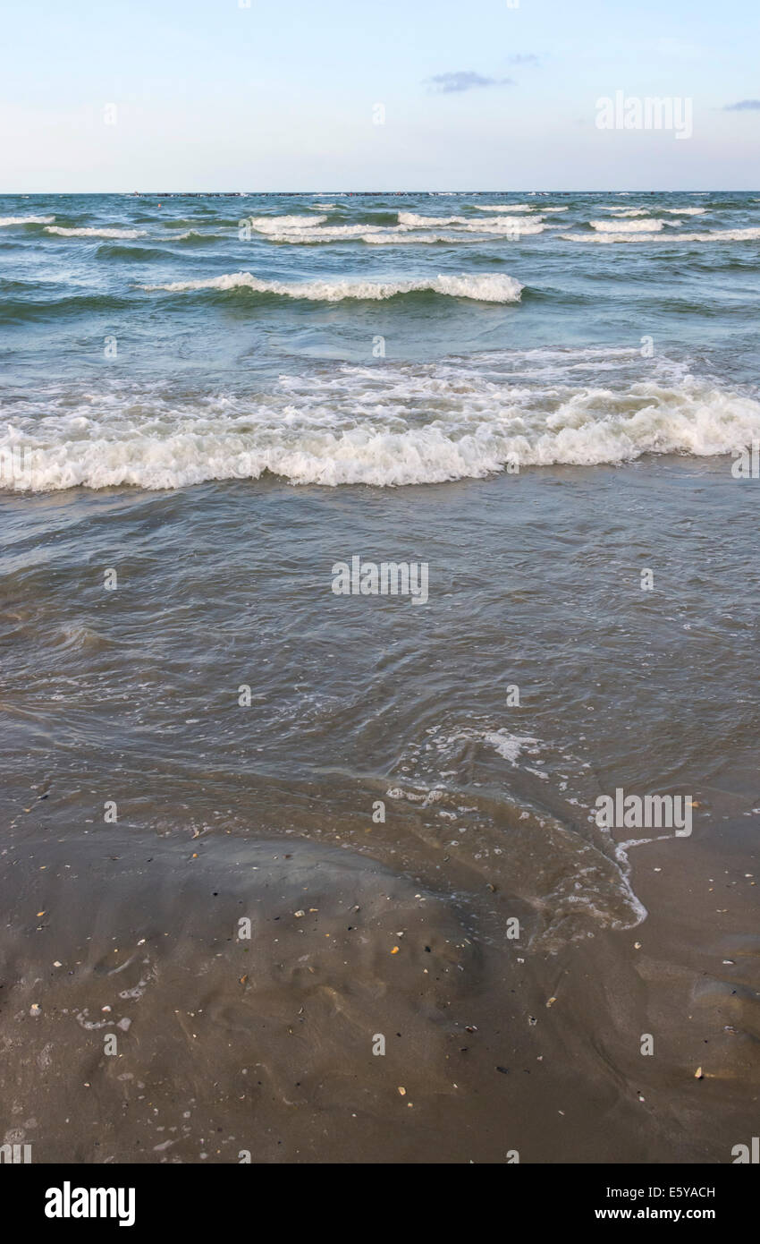 Sea waves splashing on a sandy beach Stock Photo - Alamy