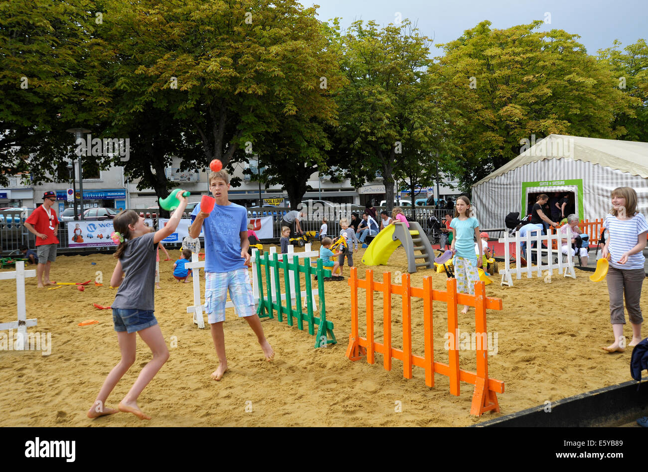 Youngsters playing with bat and ball at the Flip games festival in Parthenay Deux-Sevres France Stock Photo
