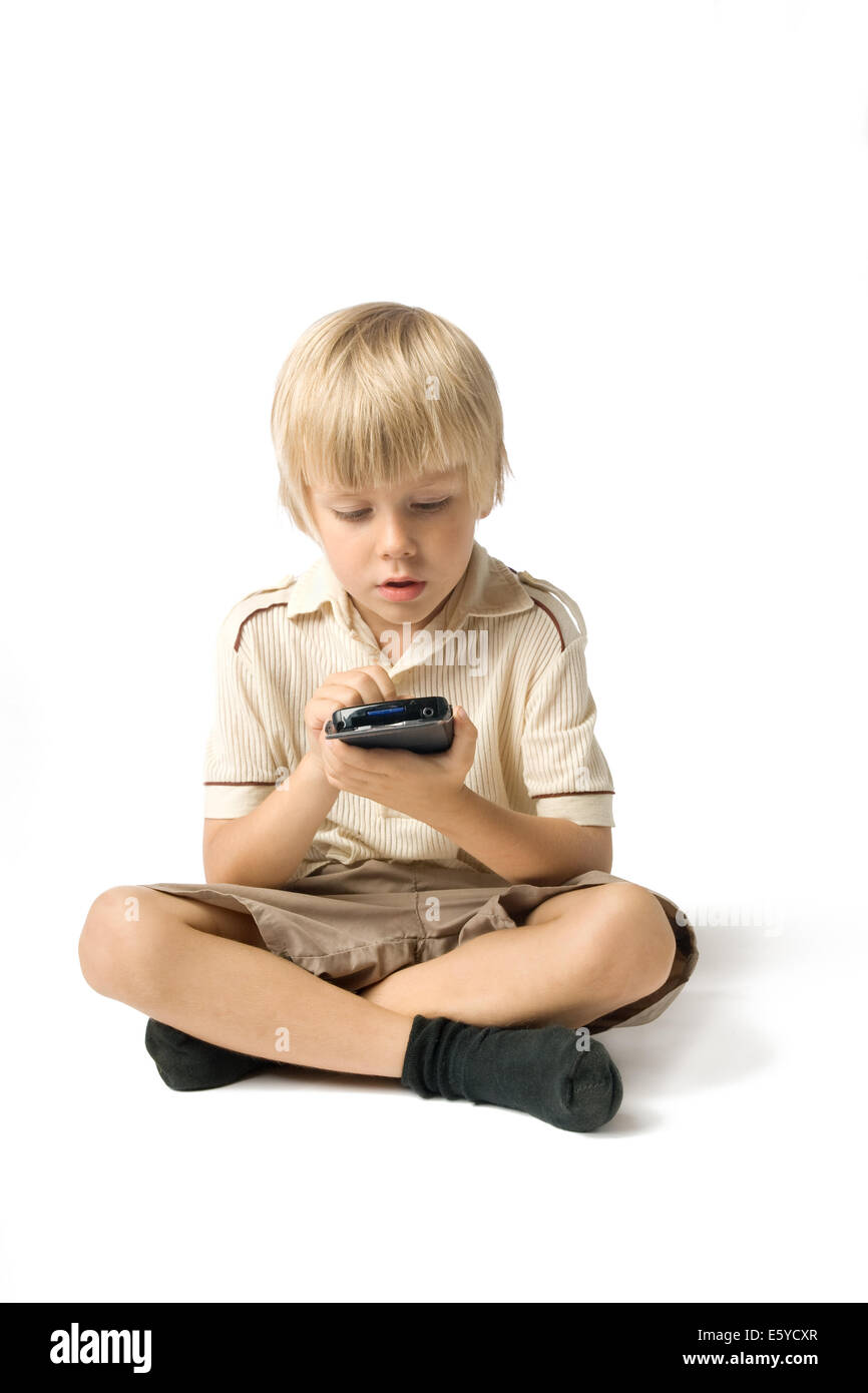 Little boy playing with PDA, studio shot Stock Photo