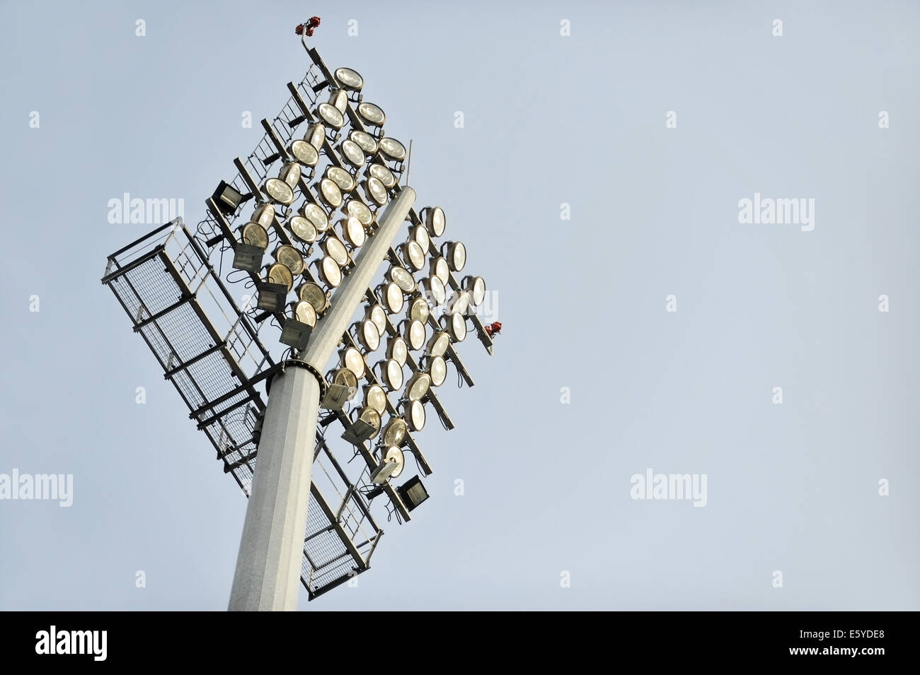 Football stadium floodlights are seen during daylight Stock Photo