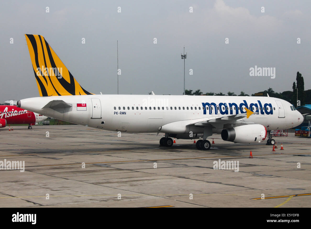 Mandala Airbus A320 rests peacefully on the ramp at Jakarta airport, prior to resuming operations. Stock Photo