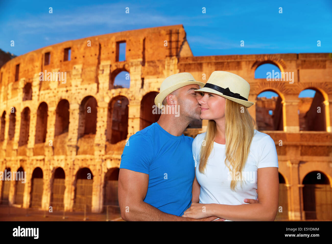 Romantic vacation to Rome, beautiful couple kissing on Colosseum background, happy traveling to Europe, summer holidays concept Stock Photo