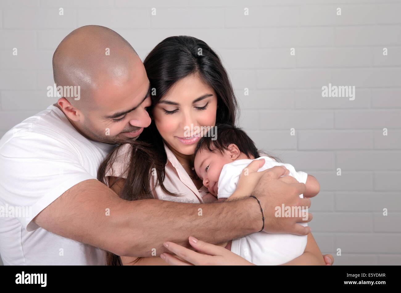 Portrait Of Happy Arabic Family At Home Young Parents Holding On Hands portrait-of-happy-arabic-family-at-home-young-parents-holding-on-hands
