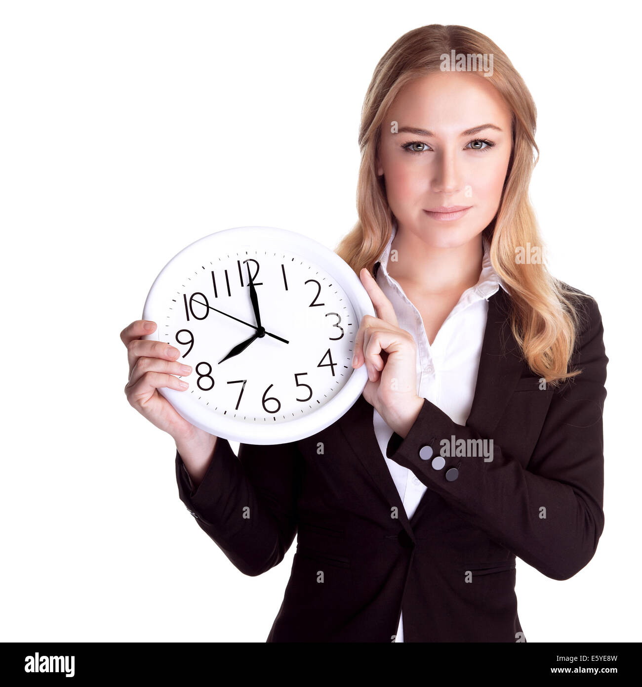 Portrait of beautiful young business woman holding in hands clock, isolated on white background, discipline and punctual concept Stock Photo