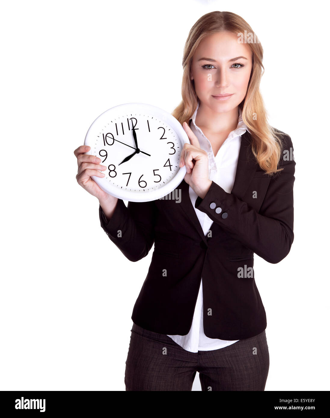 Portrait of beautiful young business woman holding in hands clock, isolated on white background, discipline and punctual concept Stock Photo