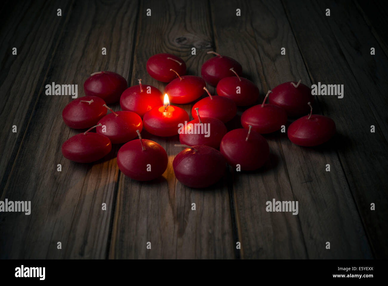 one burning candle among many off Stock Photo Alamy