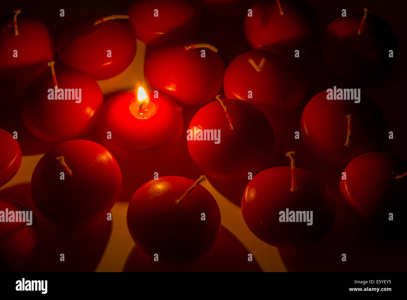 one burning candle among many off Stock Photo Alamy