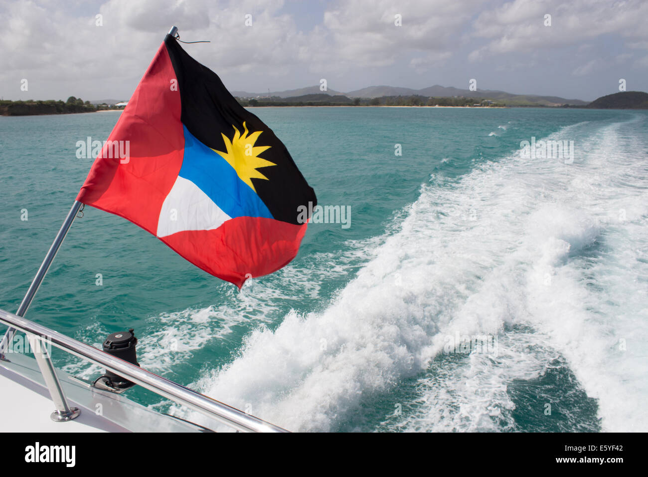 Antiguan Flag on back of a boat in the Carribean Sea Stock Photo