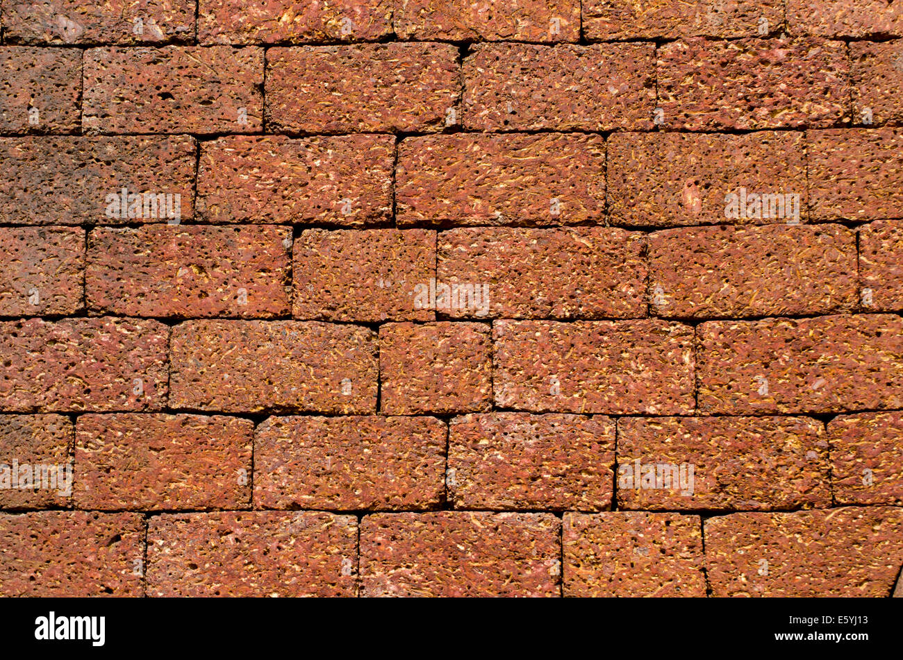 temple big brown brick wall background and texture in Goa, India Stock Photo