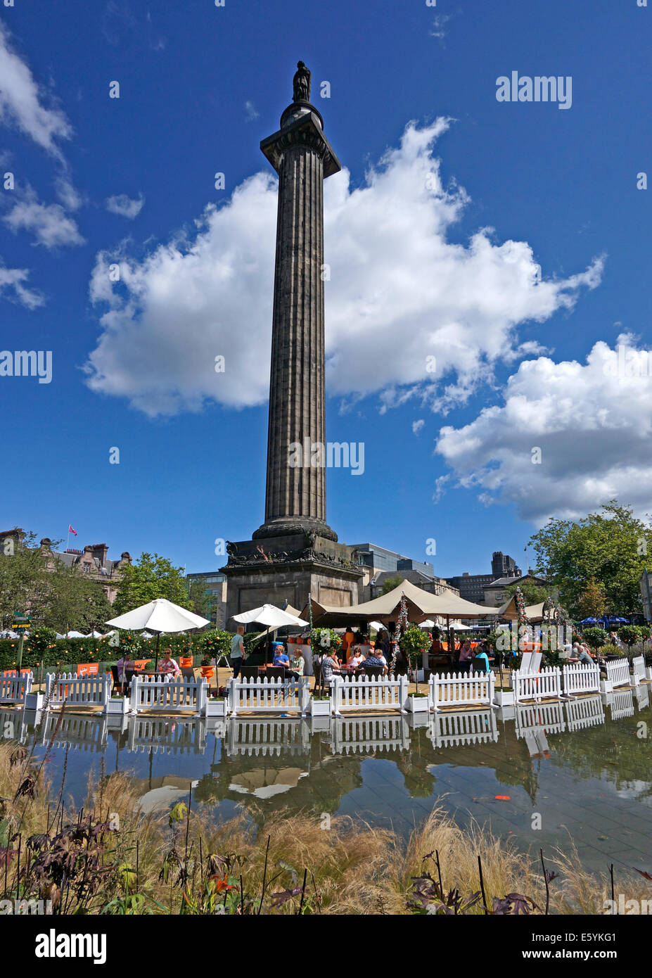 Visitors enjoying a drink under  the Melville Monument at the Edinburgh festival at St Andrew Square in Edinburgh Scotland Stock Photo