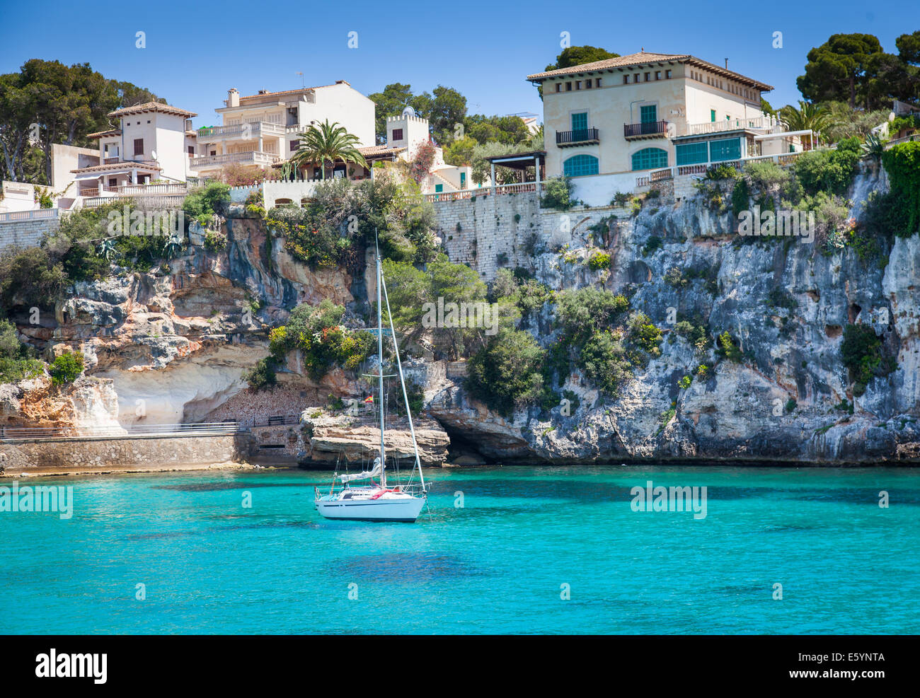 Porto Cristo , Majroca, Spain - April 23, 2014: A single yacht harboured near the cliffs Stock Photo