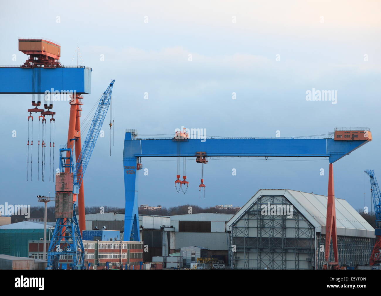 Container cranes at harbor with blue sky Stock Photo
